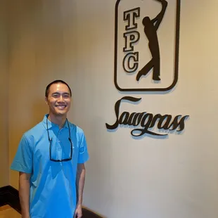 Inside the clubhouse. TPC Sawgrass logo on the wall just inside the entrance/exit where the golf bag drop is.