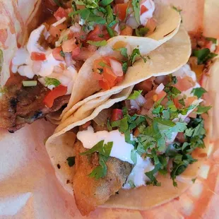 two tacoss in a basket