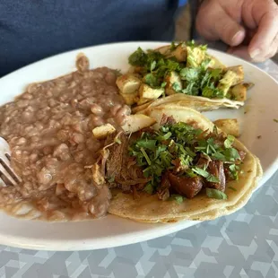 I&apos;ve Carnitas taco, one Chicken Taco and beans.