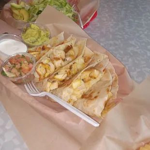 Chicken quesadilla&apos;s with side of guacamole and sour cream and salsa