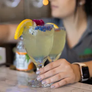 a woman holding a margarita