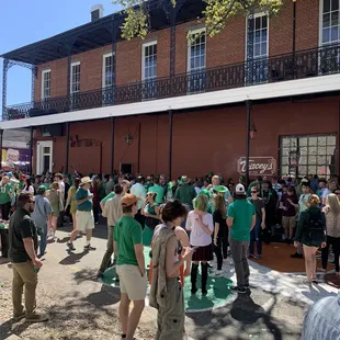 a crowd of people standing in front of a building