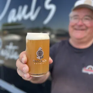 a man holding a glass of beer