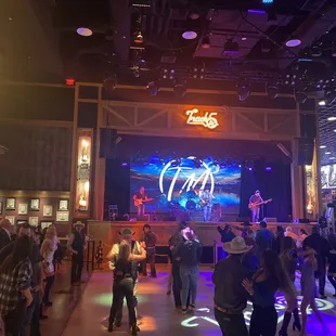 a crowd of people dancing at a concert