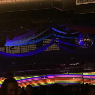 a disco scene with a disco ball in the background