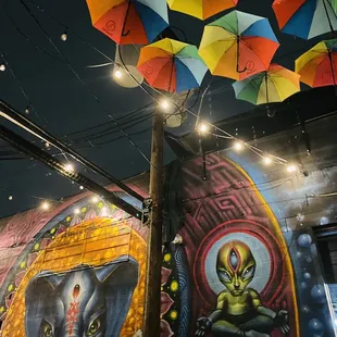 a mural of an alien and an alien with an alien face