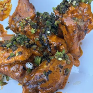 Double dipped and charred buffalo wings with jalapeños