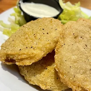 a plate of fried food with a dipping sauce