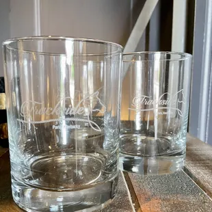 a close up of two glasses on a table