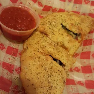 a slice of pizza with a side of sauce