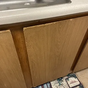 Kitchen cabinets- severe water damage. Outdated counters