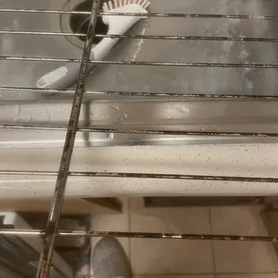 Oven grates when we moved in - bottom section cleaned by me to compare to how dirty they were