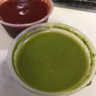 Tasty samosas  with green chilly chutney(sauce)  plus it has the taste of mint and red sweet tamarind chutney