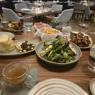 Shared plate feast! Southern greens salad, Baked brie,prosciutto and fig flatbread, and chargrilled wings.