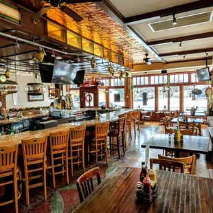 Tavern interior with bar and various seating