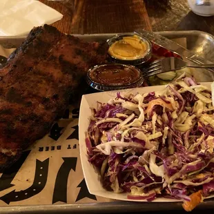 Half rack of ribs with coleslaw and two sauces