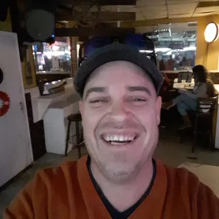 a smiling man in a restaurant