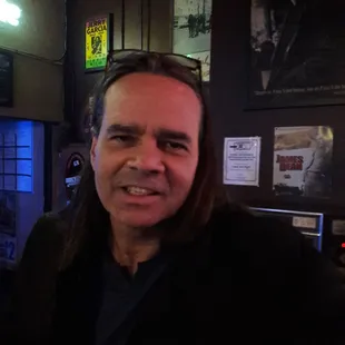 a man with long hair in a bar