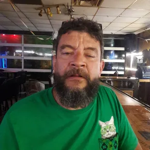 a bearded man in a green shirt