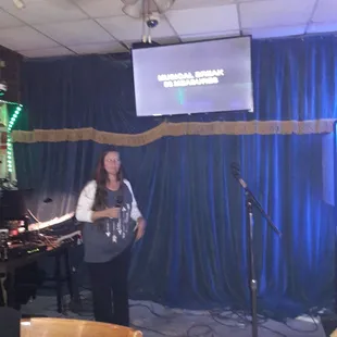 a woman standing in front of a microphone