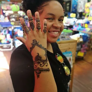 a woman with henna tattoos on her hands