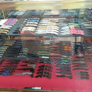a display of knives in a glass case