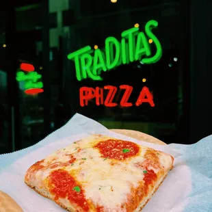 a slice of pizza on a napkin
