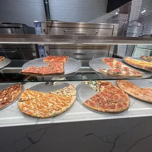 a variety of pizzas on display