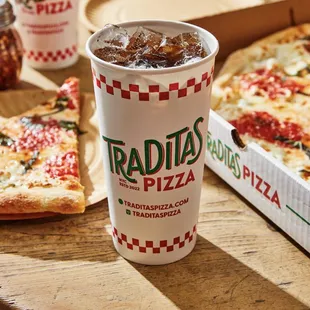 a pizza and a drink on a table