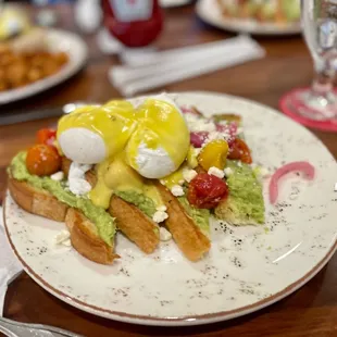 Avocado toast with eggs Benedict