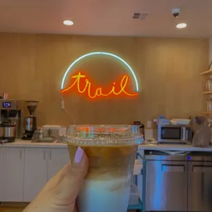 a hand holding a cup of coffee