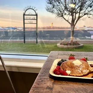 a pancake with berries and whipped cream