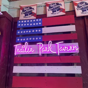 a pink flamingo in front of an american flag