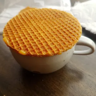 Put your Stroopwaffel on top of the hot drink and the caramel inside will melt