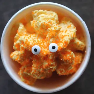 a bowl of cheesy treats with googly eyes