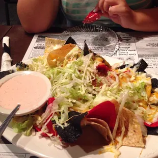 Buffalo chicken nachos with a yummy salsa ranch dipping sauce