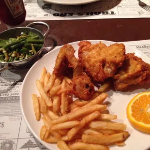 4 piece fried chicken with fries and green bean with almonds in top left corner.