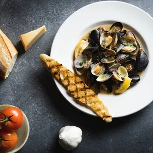 Clams &amp; Mussels

Fresh clams and mussels steamed in
white wine with lemon and butter.
Served with grilled garlic bread