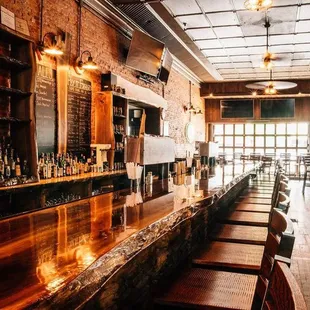 a long bar with wooden bar stools