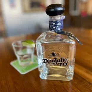 a bottle of tequila next to a shot glass