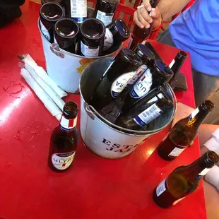 a bucket full of beer bottles