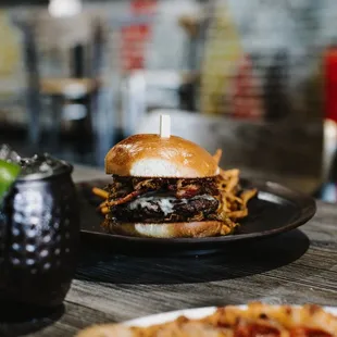 a burger and a pizza on a table
