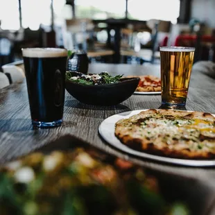 a pizza and a beer on a table