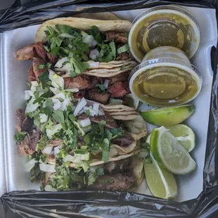 2 tripa and 2 lengua tacos on corn