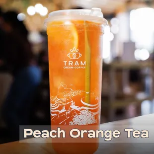 Peach Orange Tea 
A refreshing blend of sweet peach, tangy orange, and a hint of lemongrass, all steeped in Tram's signature bold tea.