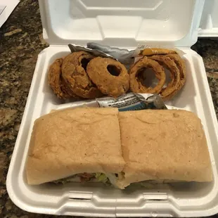 a sandwich and onion rings