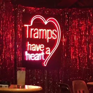 a neon sign that says tramps have a heart