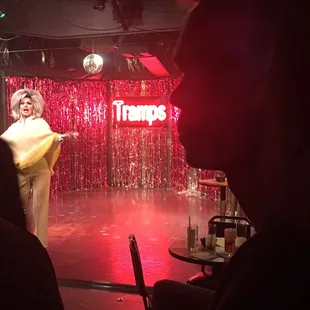 a woman in a yellow dress on stage