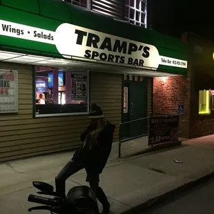 a woman leaning on a motorcycle