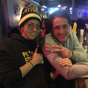 a man and a woman sitting at a bar